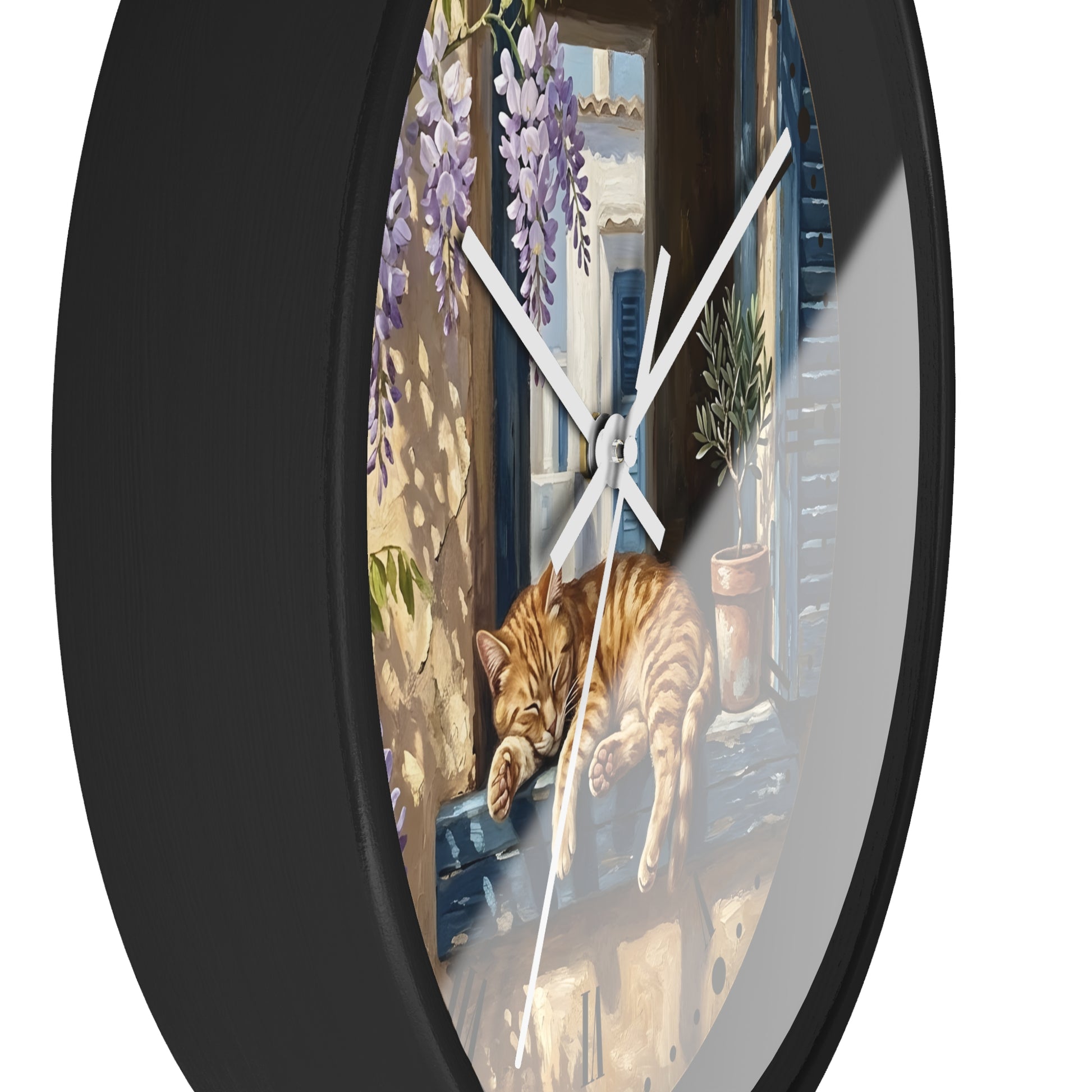 Round wall clock with a black frame and a printed illustration of an orange tabby cat sleeping on a windowsill, with purple wisteria and a sunlit balcony scene.