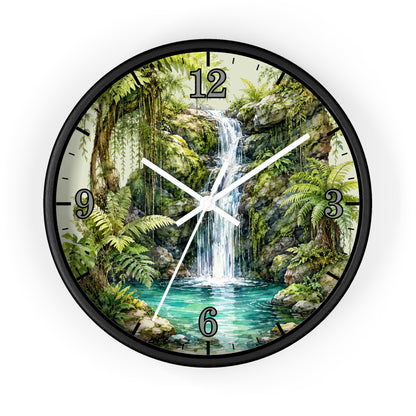 A round wall clock with a black frame and a printed tropical jungle waterfall scene on the face. The clock has black Arabic numerals for 12, 3, 6, and 9, with black hour and minute markers and white clock hands.