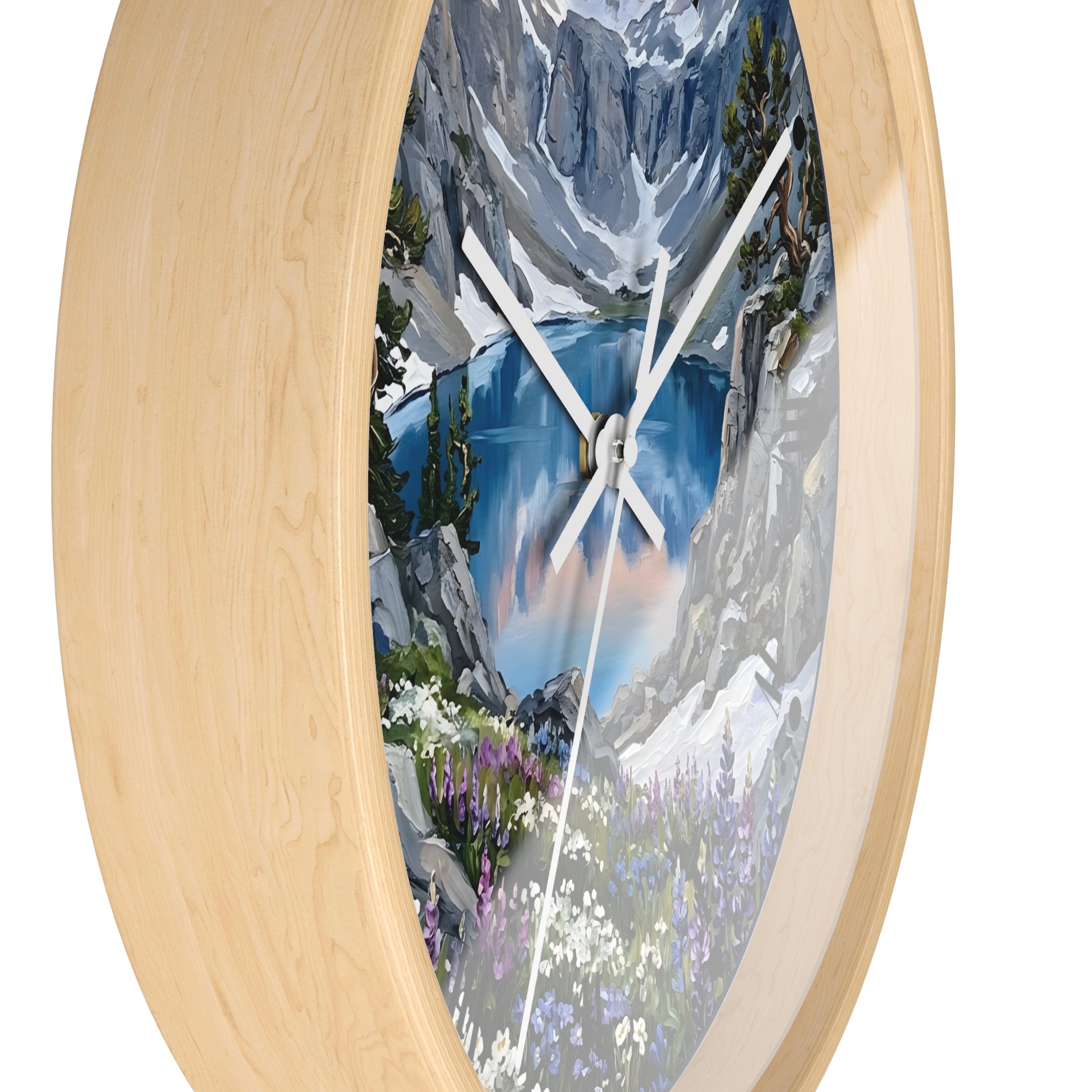 An oval wall clock with a light natural wood frame and a scenic mountain lake print on the face, shown against a plain white background.