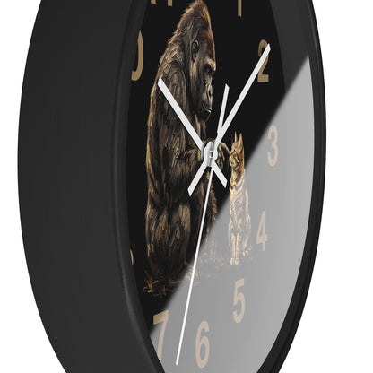 A round wall clock with a black frame and a printed face featuring a large gorilla and a cat on a dark background, with gold-colored numerals and white hands.