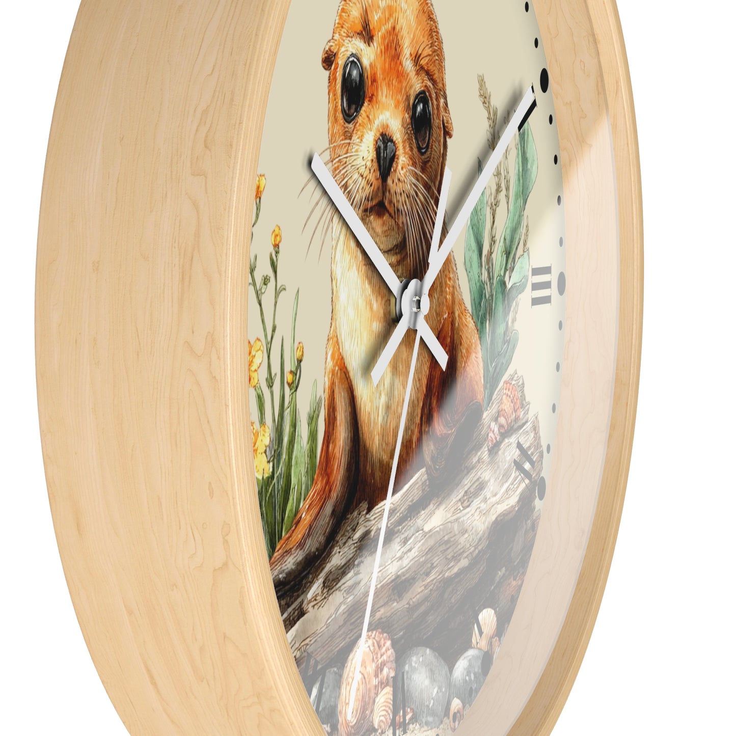 Round wall clock with a light natural wood frame and a printed face featuring a seal pup sitting on a log with seashells and small yellow flowers, shown on a white background.