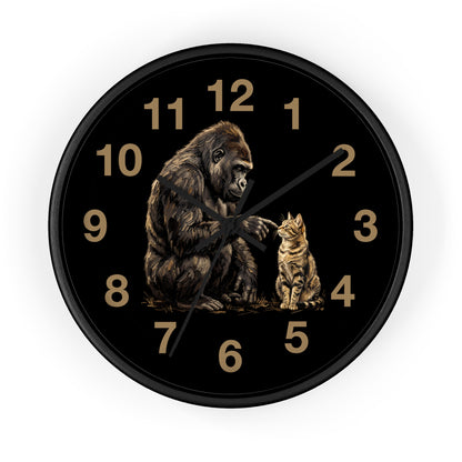 A round black wall clock with a detailed illustration of a gorilla and a cat on the face, with gold-colored numerals and hands, shown against a plain white background.