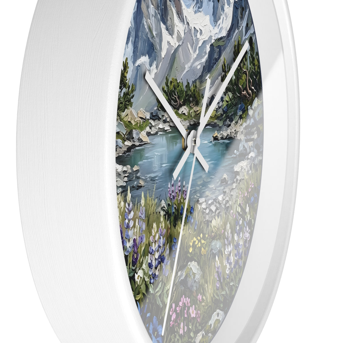 An oval wall clock with a white frame and a printed landscape design featuring a mountain lake, trees, and wildflowers. The clock is shown against a plain white background.
