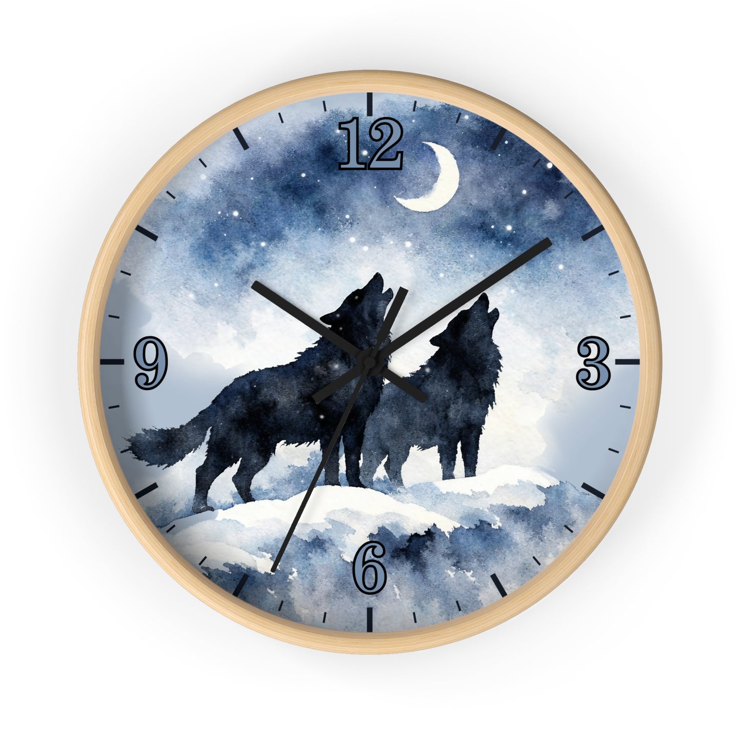 Round wall clock with a light wood frame and a printed night sky dial showing two black wolf silhouettes howling under a crescent moon and stars. The clock has blue-toned watercolor-style graphics, black numerals, and black hands, photographed on a plain white background.
