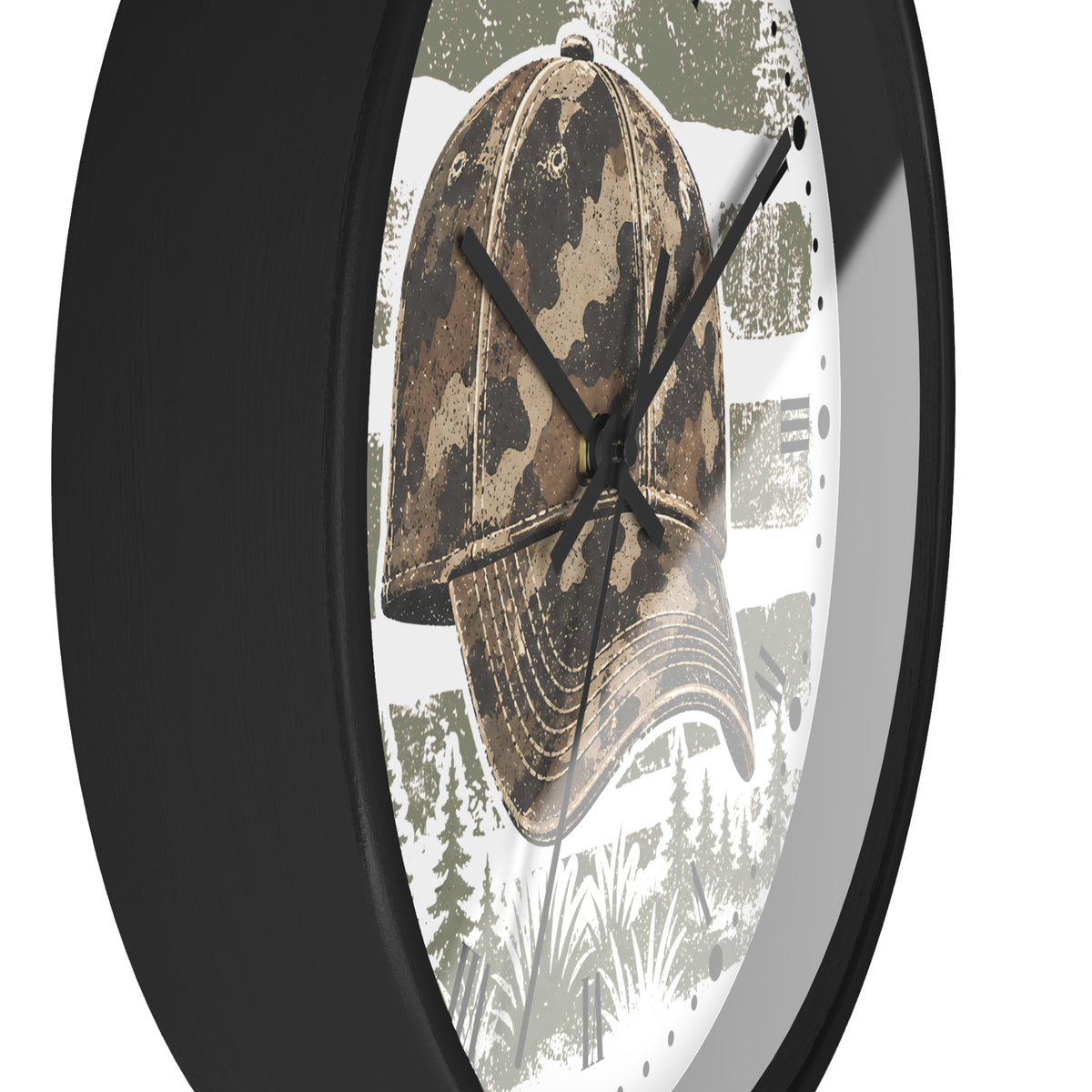 A close-up of a round wall clock with a black frame and a printed face featuring a camouflage baseball cap over a forest scene in muted green, brown, and white tones.