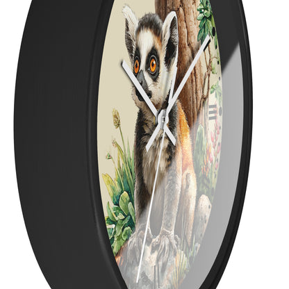 Round wall clock with a black frame and a printed illustration of a ring-tailed lemur on the face, with white clock hands and a light gray outer background.