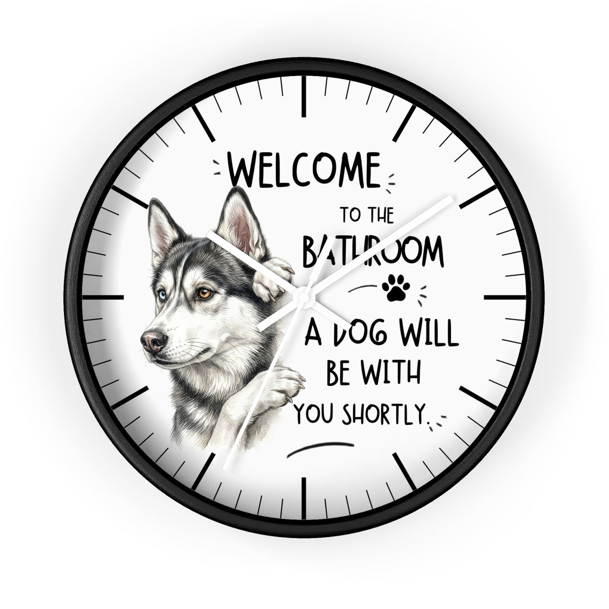 A round wall clock with a black frame and white face, featuring a detailed illustration of a husky dog and the humorous text 'WELCOME TO THE BATHROOM A DOG WILL BE WITH YOU SHORTLY.'.