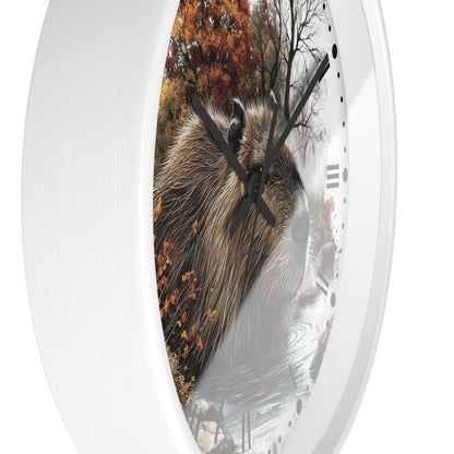 Round wall clock with a white frame and a printed nature scene featuring a capybara, autumn trees, and water, with black hands and Roman numerals.