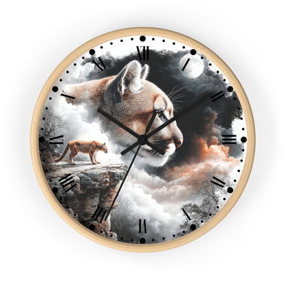 A round wall clock with a light wood frame and a surreal printed dial featuring a large cat head, a smaller cat standing on a cliff, clouds, moon, and dark sky. The clock is centered on a plain white background.