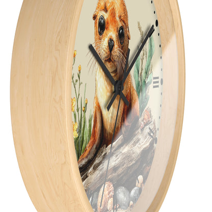 Round wall clock with a light natural wood frame and a printed illustration of an otter on the face, with black hands and minimalist hour markers.