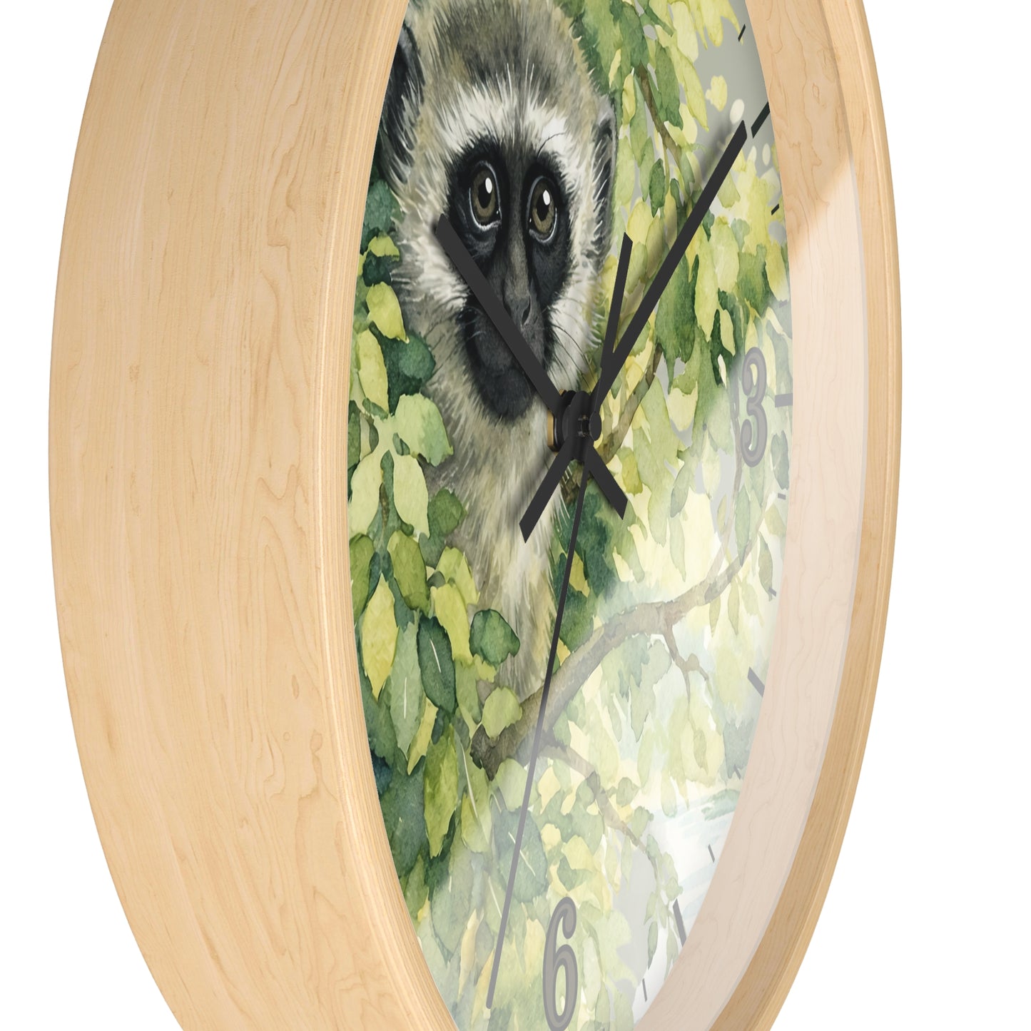 Round wall clock with a light natural wood frame and a printed center featuring a vervet monkey among green leaves, with black clock hands and gray numerals.