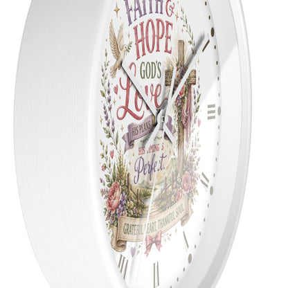 A white round wall clock with a vintage-style religious design on the face, featuring the words 'Faith, Hope, Love', a cross, floral elements, and Roman numeral hour markers.