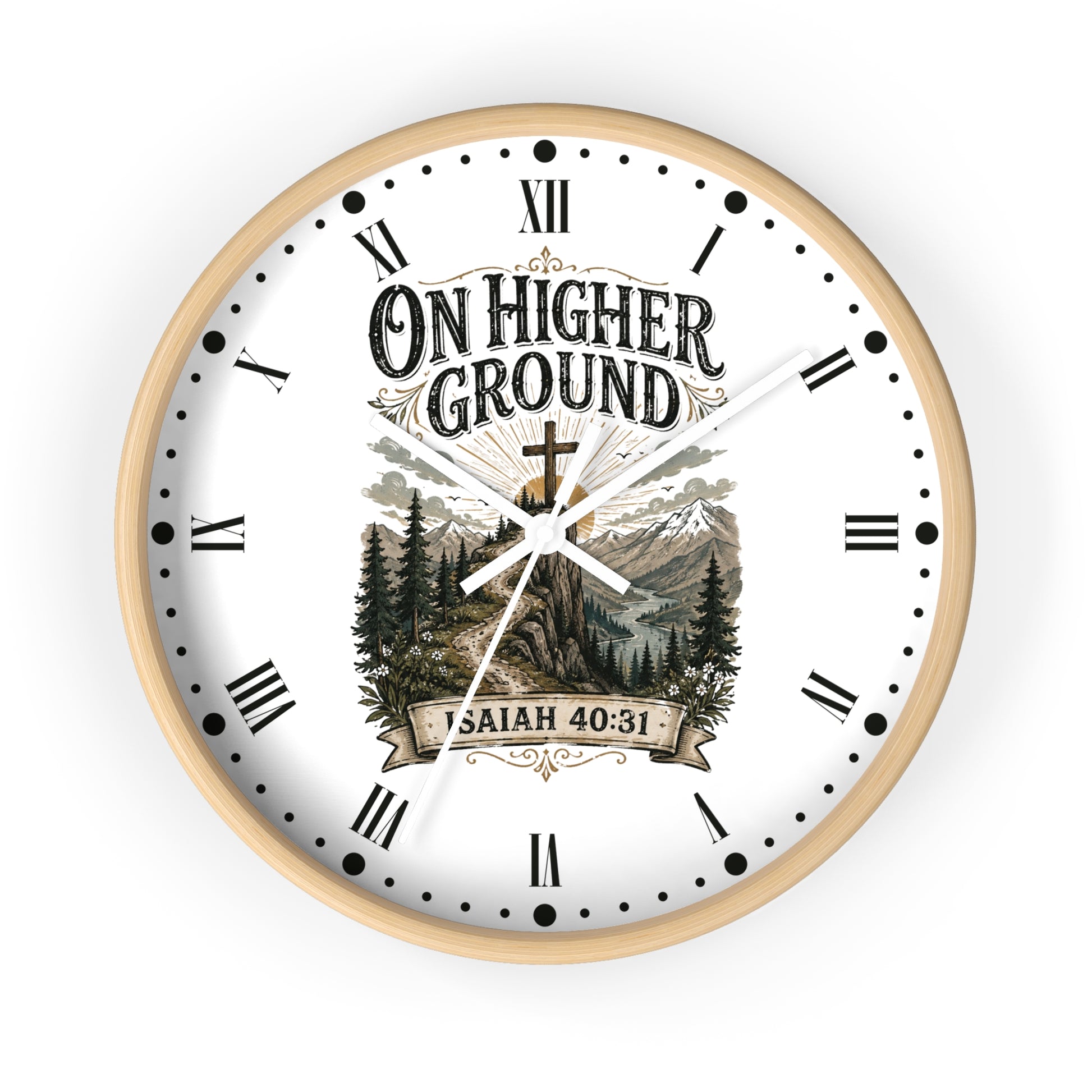 A round wall clock with a light wood frame and a white face featuring the text 'ON HIGHER GROUND' and 'ISAIAH 40:31' over a scenic mountain-and-trees illustration. The clock uses black Roman numerals and hands on a clean white background.