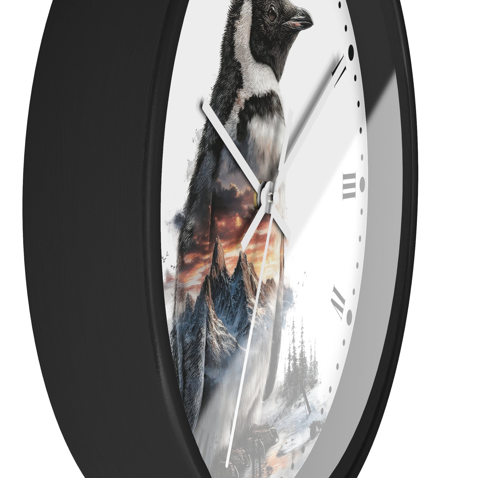 A round wall clock with a black frame and a white face featuring a printed penguin and mountain landscape design, shown against a plain white background.
