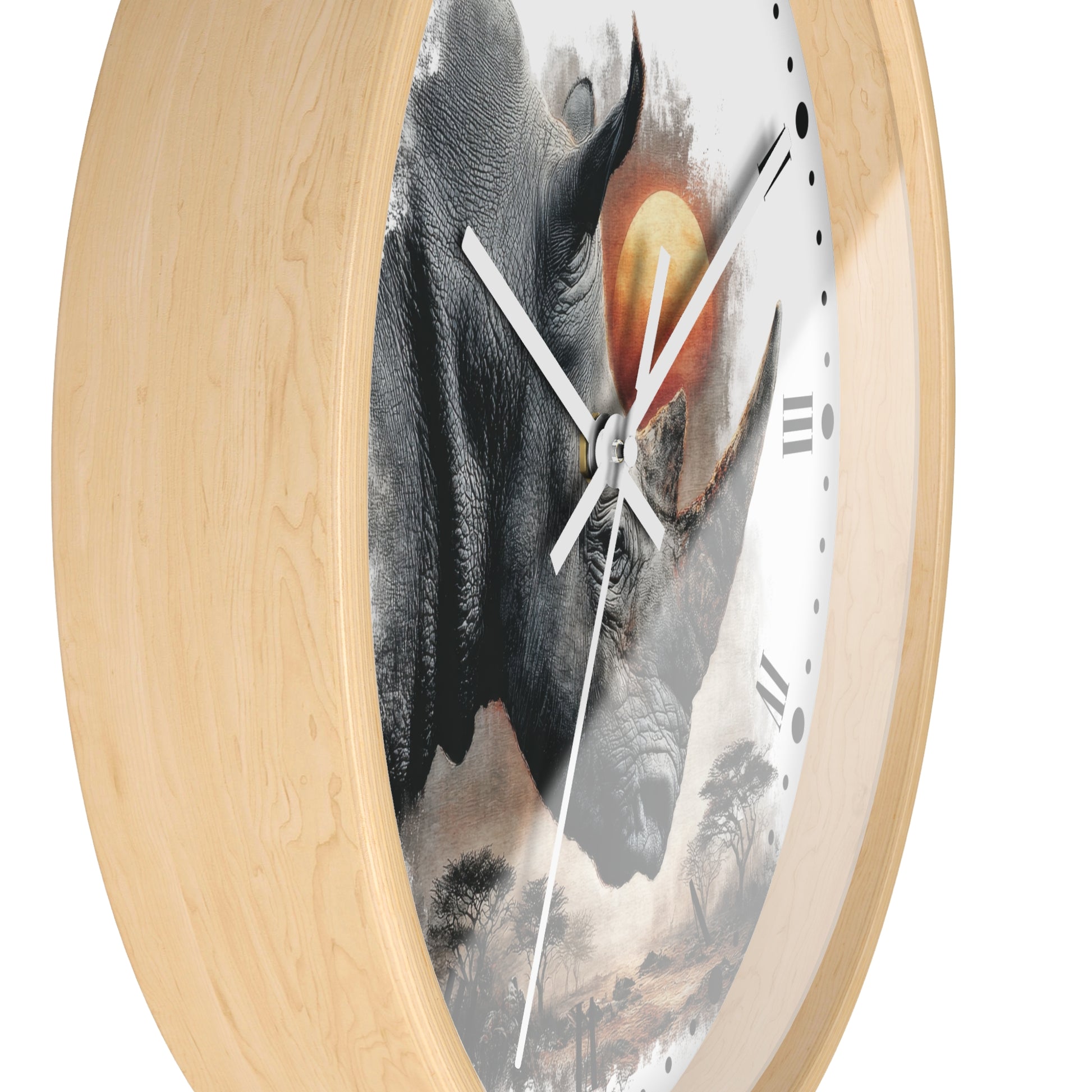 A round wall clock with a light natural wood frame and a white dial featuring a large rhinoceros illustration with a warm orange-yellow sun and faint landscape details.