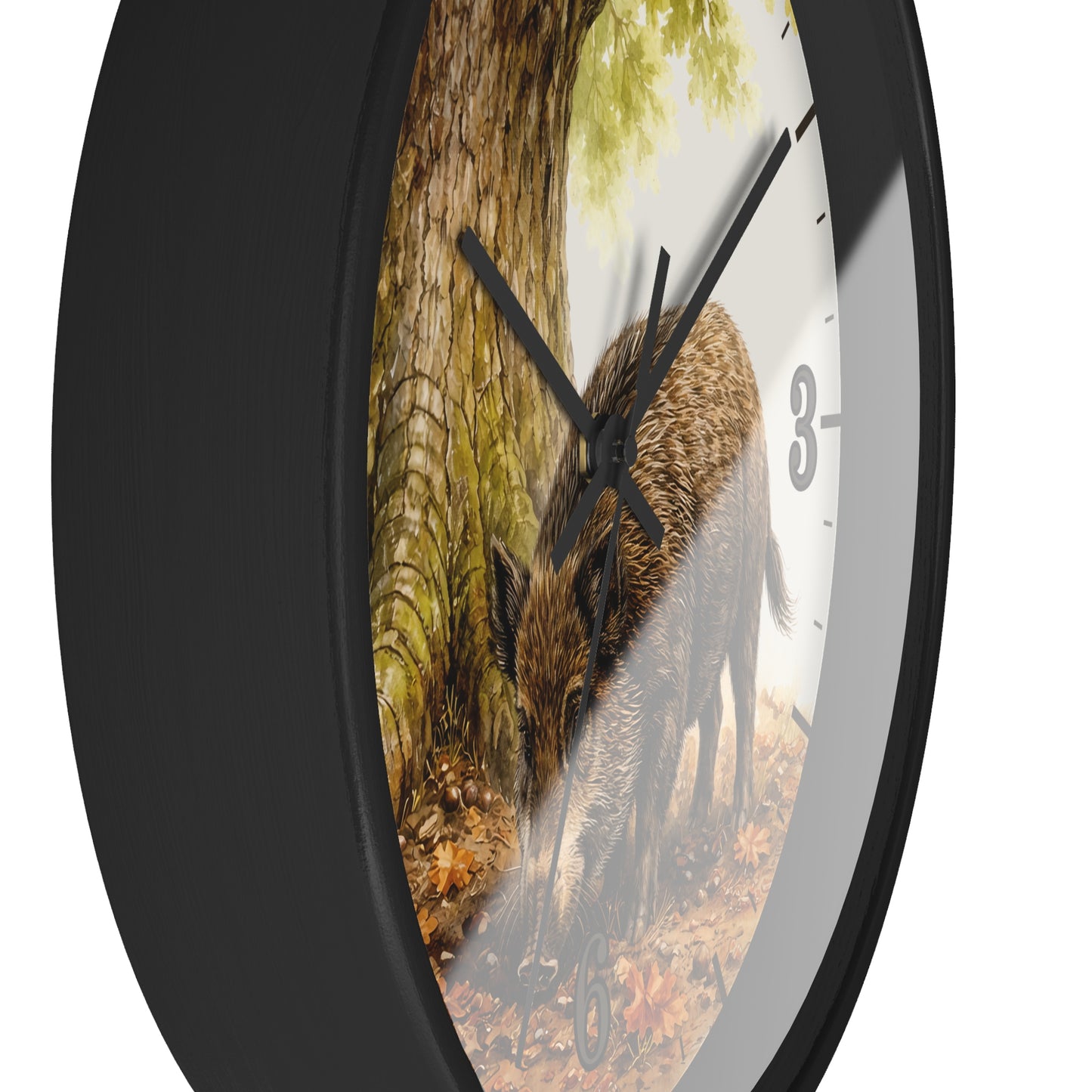 A round wall clock with a black frame and a printed nature scene on the face showing a wild boar in a forest, photographed against a plain white background.
