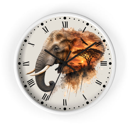 A round wall clock with a white frame and a printed elephant design over a savanna sunset scene. The clock face has an off-white background with black Roman numerals and hands.
