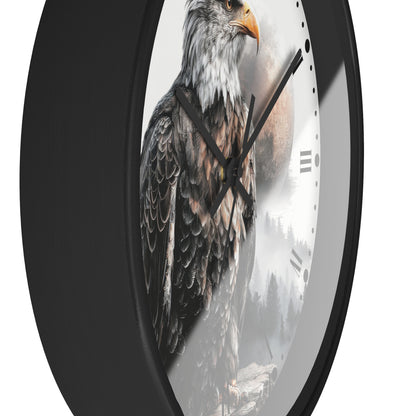 A round wall clock with a black frame and a printed face featuring a detailed bald eagle over a misty forest scene, shown against a plain white background.