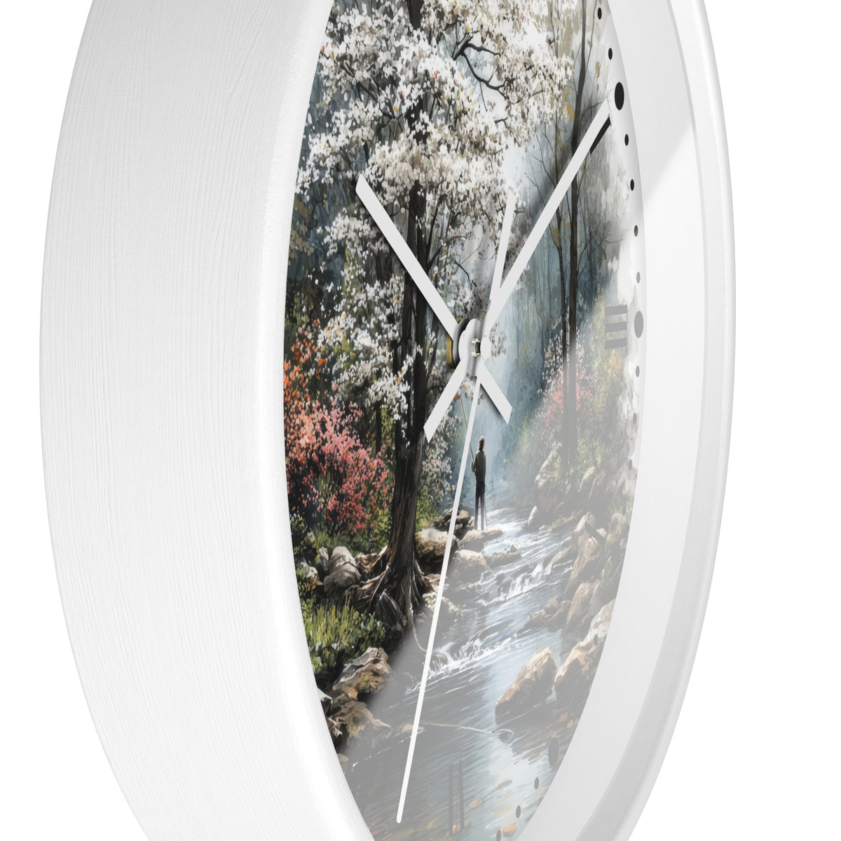 A round wall clock with a white textured frame and a printed scenic dial showing a forest stream with white blossoms, photographed against a plain white background.