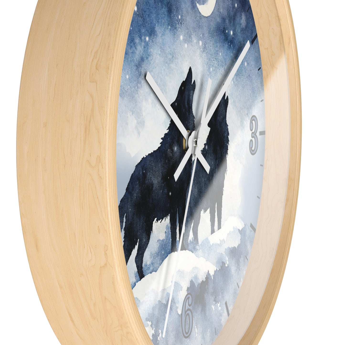 Round wall clock with a light natural wood frame and a printed face showing two black howling wolves under a snowy blue night sky. The clock has white hands, a moon at the top, and partial gray numerals at 3 and 6.