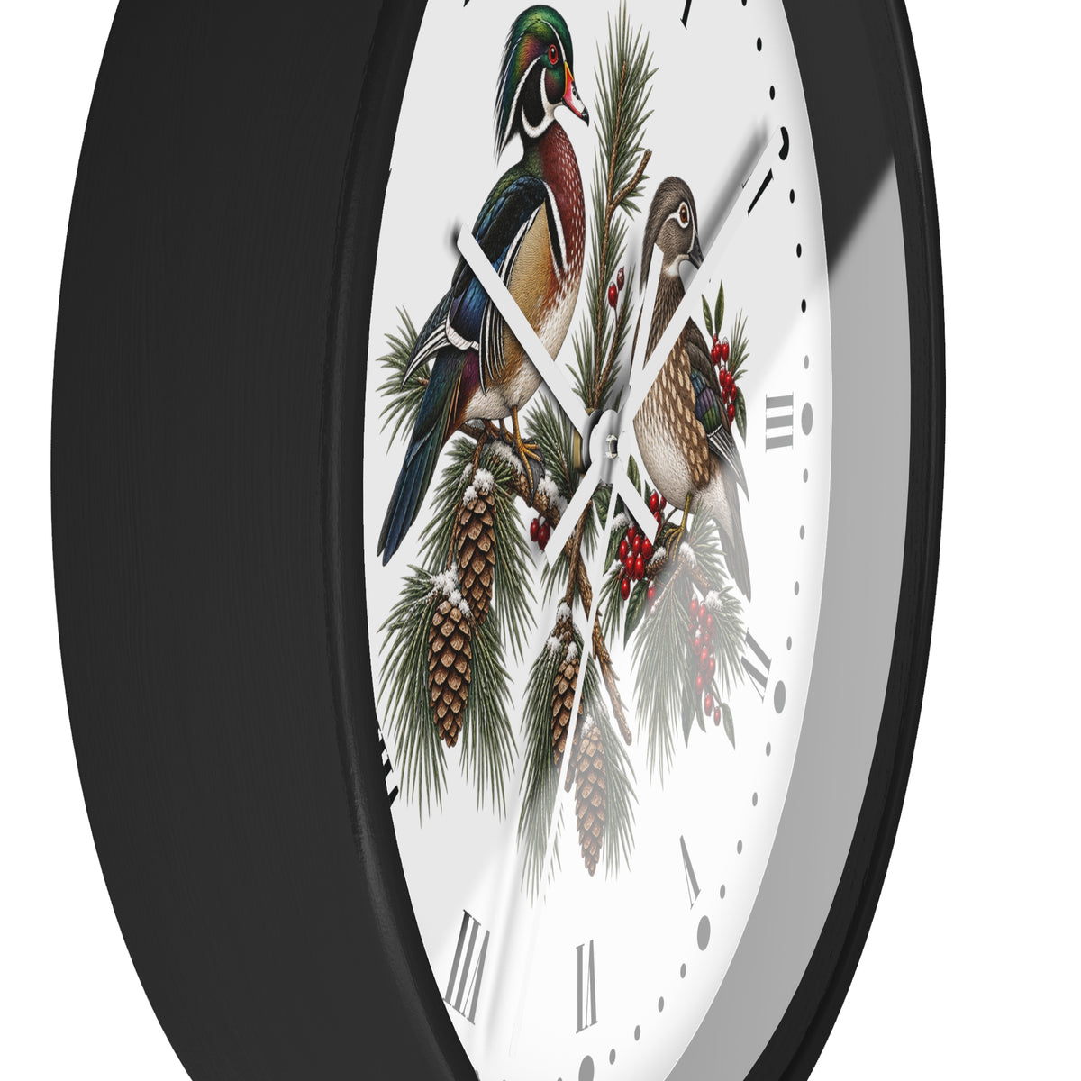 A close-up of a wall clock with a black frame and a white face featuring a detailed illustration of two wood ducks perched on pine branches with pinecones and red berries.