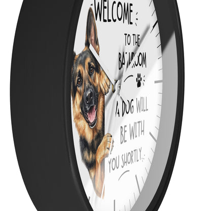 A round wall clock with a black frame and a white face, featuring a German Shepherd illustration and the text 'WELCOME TO THE BAILROOM A DOG WILL BE WITH YOU SHORTLY.