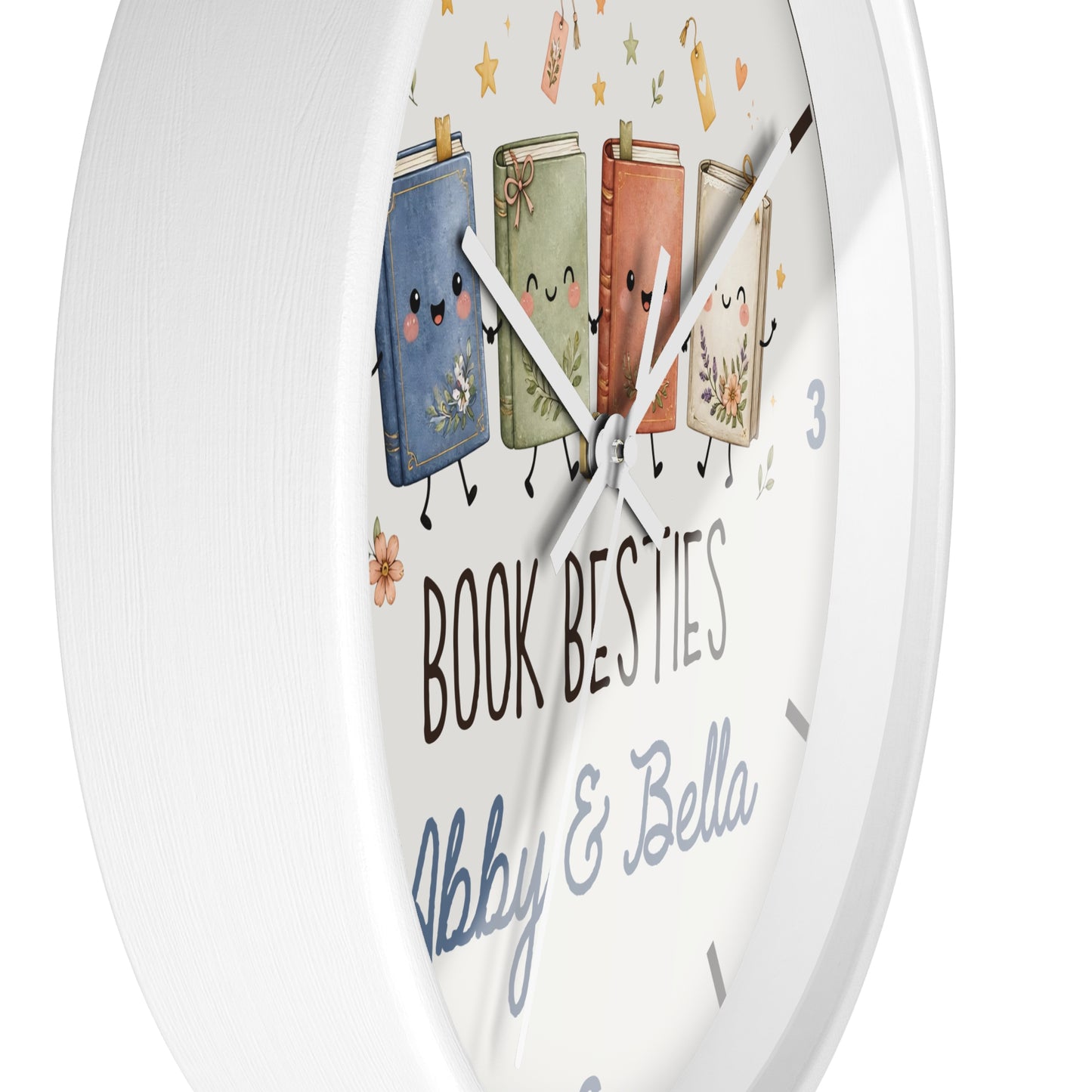 A round white wall clock with a whimsical illustration of four smiling book characters and the text 'BOOK BESTIES Abby & Bella' on the clock face.