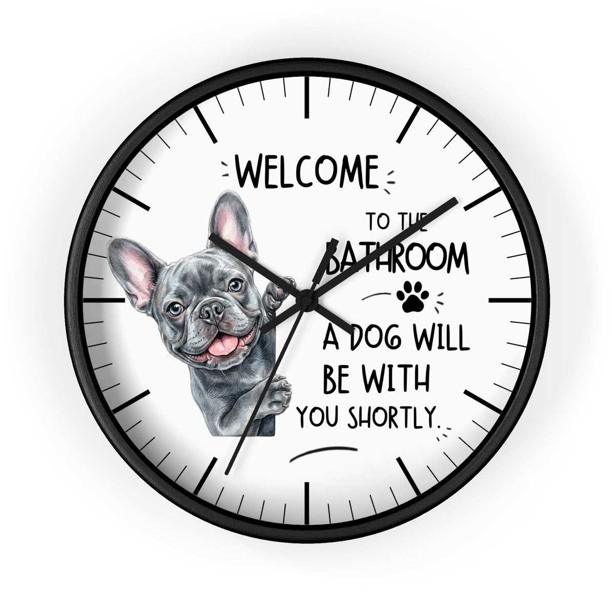 A round wall clock with a black frame and white face, featuring a French bulldog illustration and the text 'WELCOME TO THE BATHROOM A DOG WILL BE WITH YOU SHORTLY.' on a light gray background.