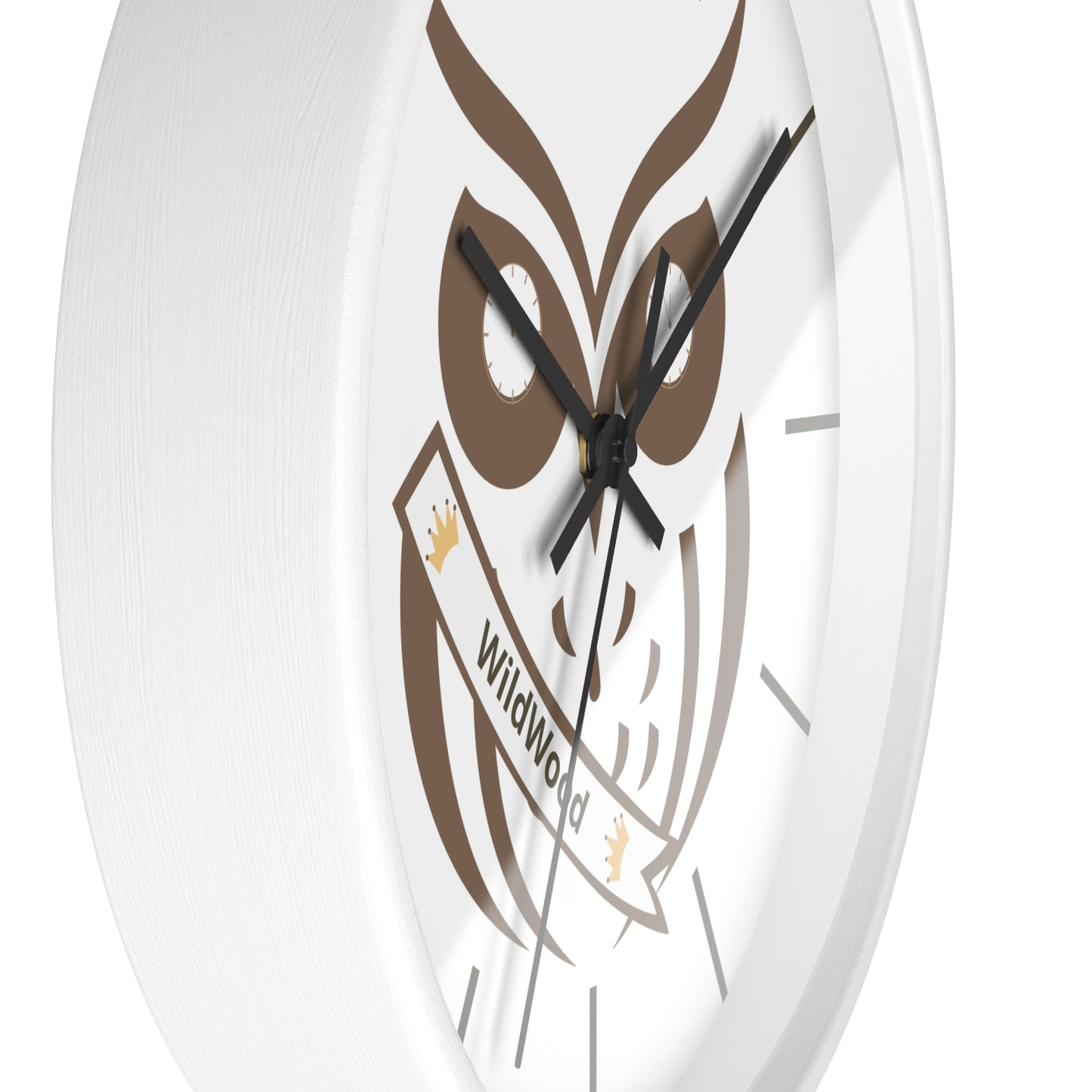 A close-up of a round white wall clock featuring a brown owl graphic and a banner that reads 'Wildwood'.