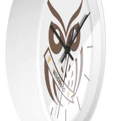 A close-up of a round white wall clock featuring a brown owl graphic and a banner that reads 'Wildwood'.