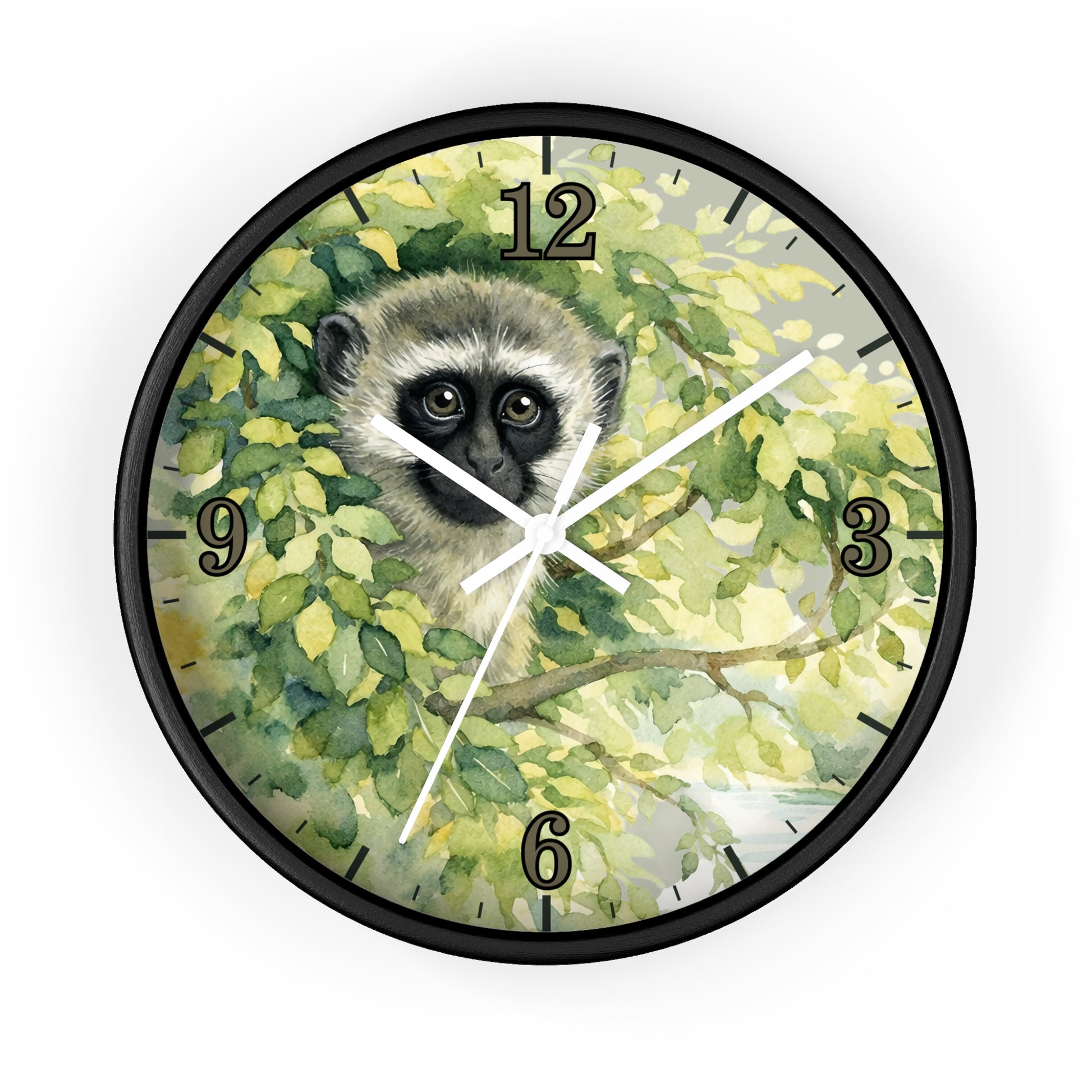 Round wall clock with a black frame and a printed illustration of a vervet monkey face among green and yellow leaves on the clock face, with black Arabic numerals and white hands.