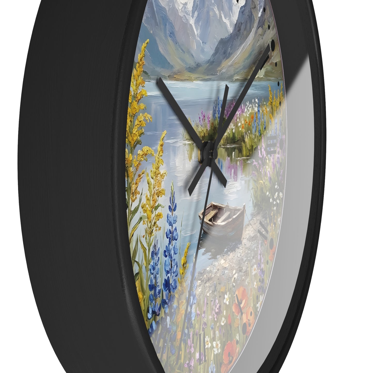 Round wall clock with a black frame and a scenic landscape print featuring a lake, mountains, wildflowers, and a rowboat, shown against a white background.