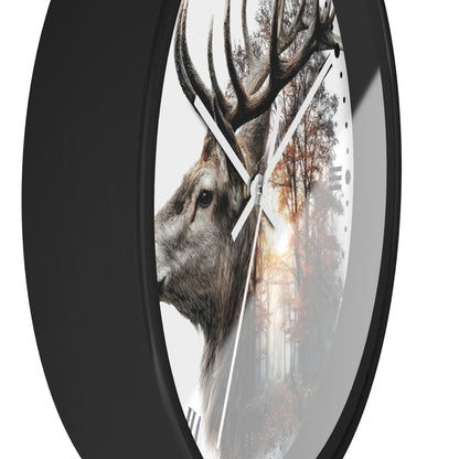 A round wall clock with a black frame and a printed design featuring a deer head over an autumn forest scene, shown against a plain white background.