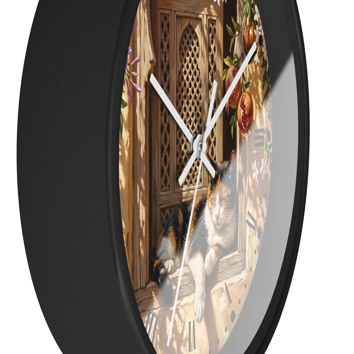 A round wall clock with a black frame and a printed scene on the face showing a calico cat resting by a wooden door, photographed against a plain white background.