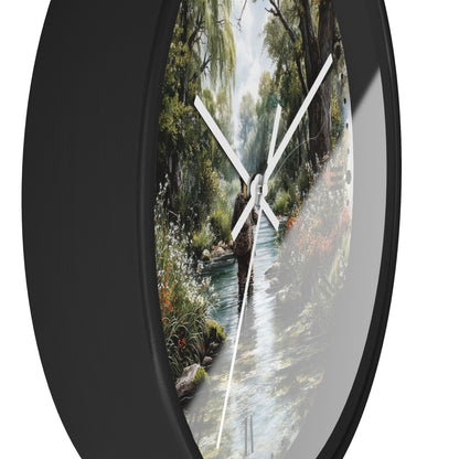 Round wall clock with a black frame and a scenic nature print of a person walking along a stream, shown against a white background.