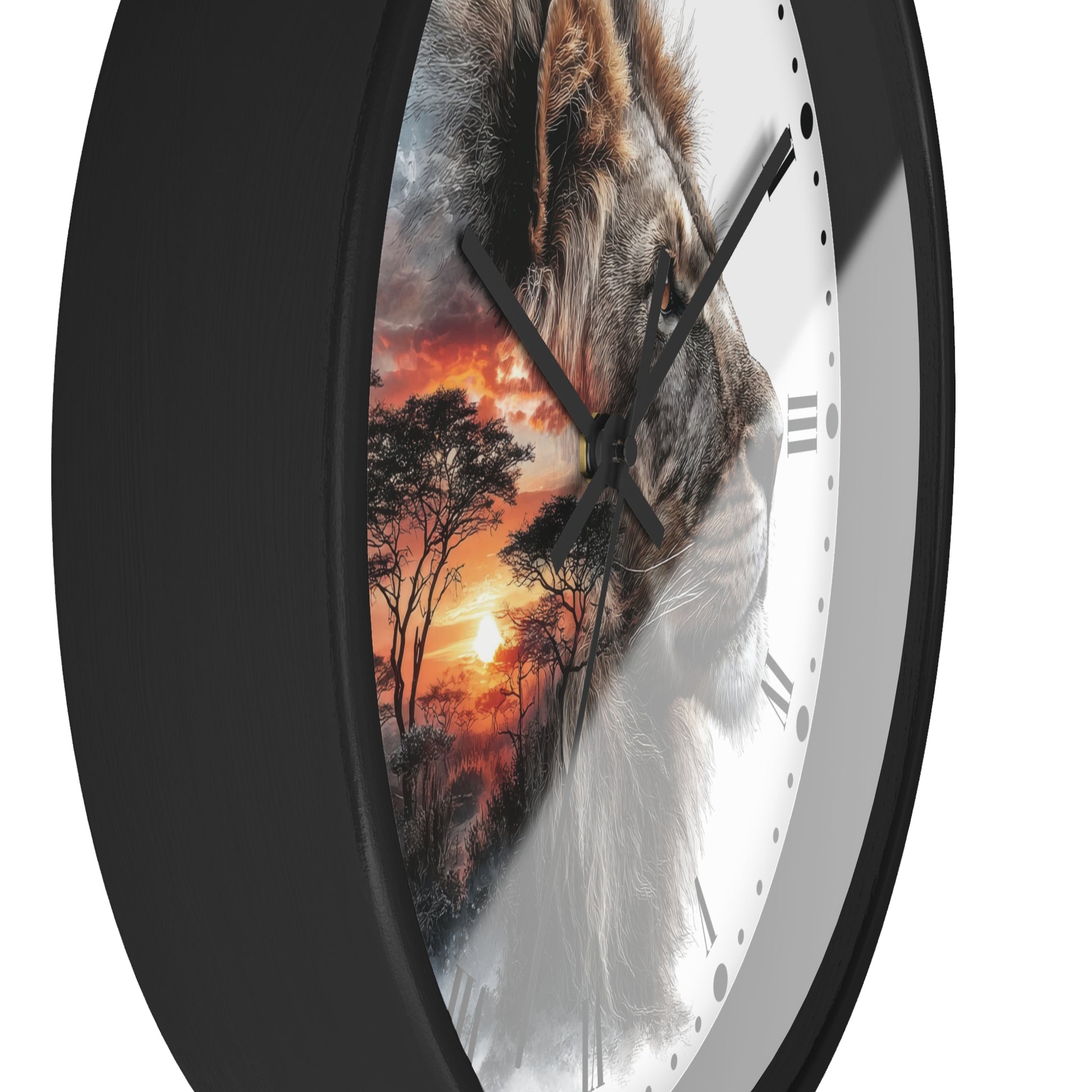 A close-up of a round wall clock with a black frame and a white dial, featuring a split design: one half shows a lion face and the other half shows an orange sunset landscape. The clock is shown against a plain white background.