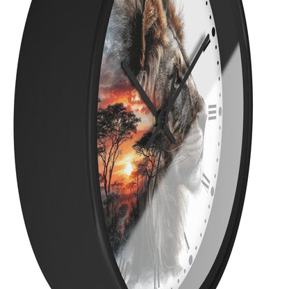 A close-up of a round wall clock with a black frame and a white dial, featuring a split design: one half shows a lion face and the other half shows an orange sunset landscape. The clock is shown against a plain white background.