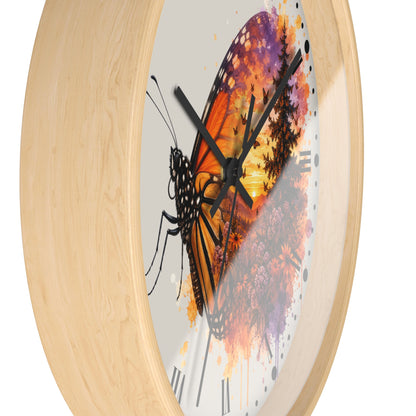 Round wall clock with a light natural wood frame and a printed butterfly artwork on the face. The butterfly design features orange, purple, black, and yellow tones over a white background with black Roman numerals.