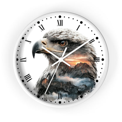 Round wall clock with a white frame and face, featuring a large eagle head illustration over a mountain sunset scene. Roman numerals mark the hours, with black dot markers around the outer edge and white clock hands.