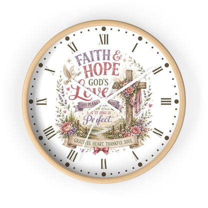 A round wall clock with a light wood frame and a white face featuring a religious illustration and the words 'FAITH & HOPE GOD'S Love' and 'PERFECT' in a decorative floral wreath design.