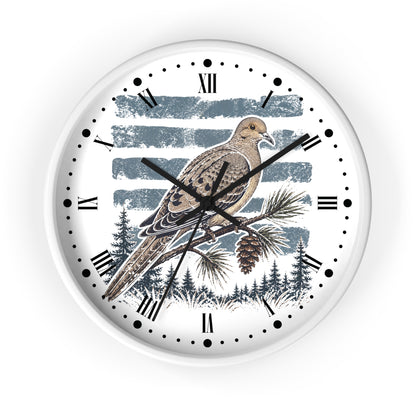 A round wall clock with a white frame and a printed bird illustration on the face. The design shows a brown and beige dove bird perched on a pine branch against a blue-gray striped background, with black Roman numerals and black clock hands.