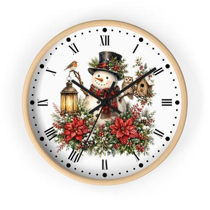 A round wall clock with a light wood frame and a white face featuring a festive Christmas illustration of a snowman, red poinsettias, green foliage, a bird, a lantern, and a birdhouse, with black Roman numerals and hands.