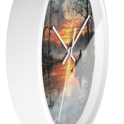 An oval wall clock with a white frame and white hands, featuring a scenic print of a sunset over a misty forest and water.