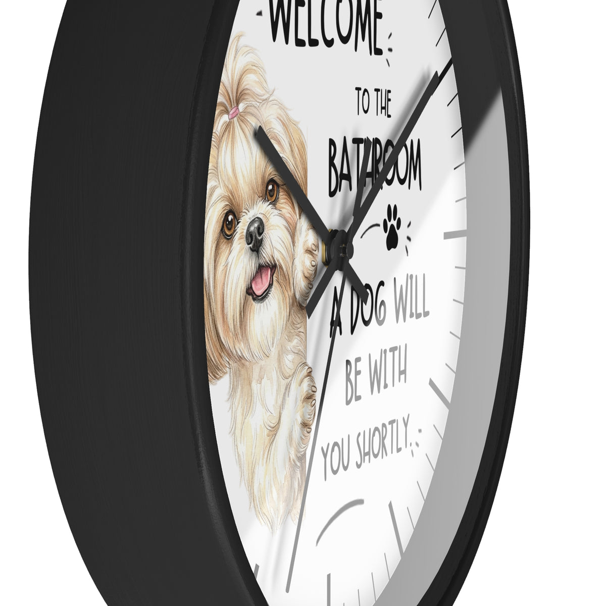 A round wall clock with a black frame and a white face featuring a cartoon Shih Tzu dog illustration and the text 'WELCOME TO THE BATHROOM A DOG WILL BE WITH YOU SHORTLY'.