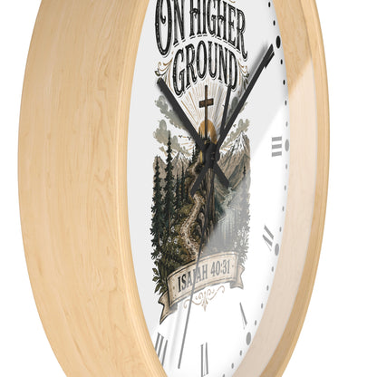 A round wall clock with a light natural wood frame and a white face featuring a scenic mountain-and-tree illustration, the words “ON HIGHER GROUND,” and a banner reading “ISAIAH 40:31.”.