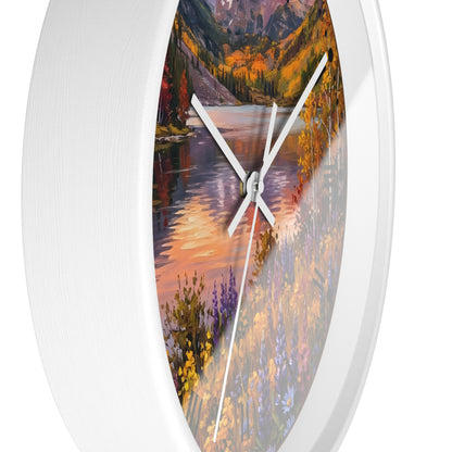 Round wall clock with a white frame and a scenic landscape print of a river flowing through a mountain valley in autumn colors, featuring white hands.