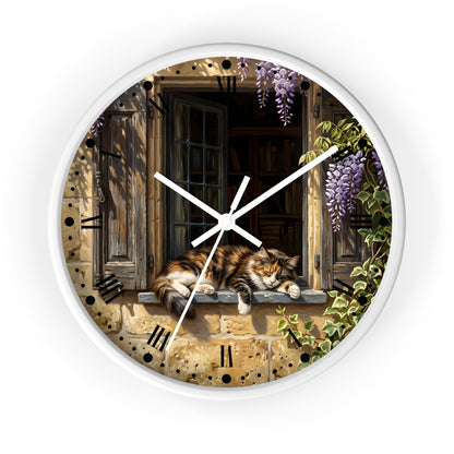 Round wall clock with a white frame and a printed illustration of a fluffy orange tabby cat resting on a stone window sill, surrounded by purple wisteria flowers and green ivy, with black Roman numerals and white clock hands.