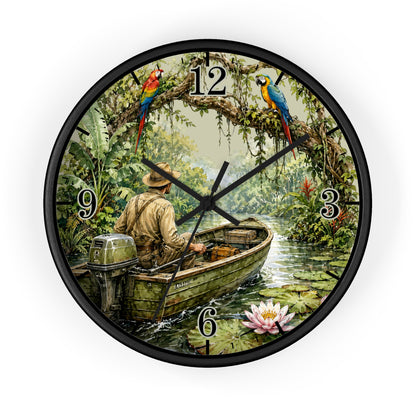 Round wall clock with a black frame and a tropical jungle scene printed on the face. A man in a motorboat is visible near the lower left, with colorful parrots at the 12 and 3 positions and a pink water lily near the 6.