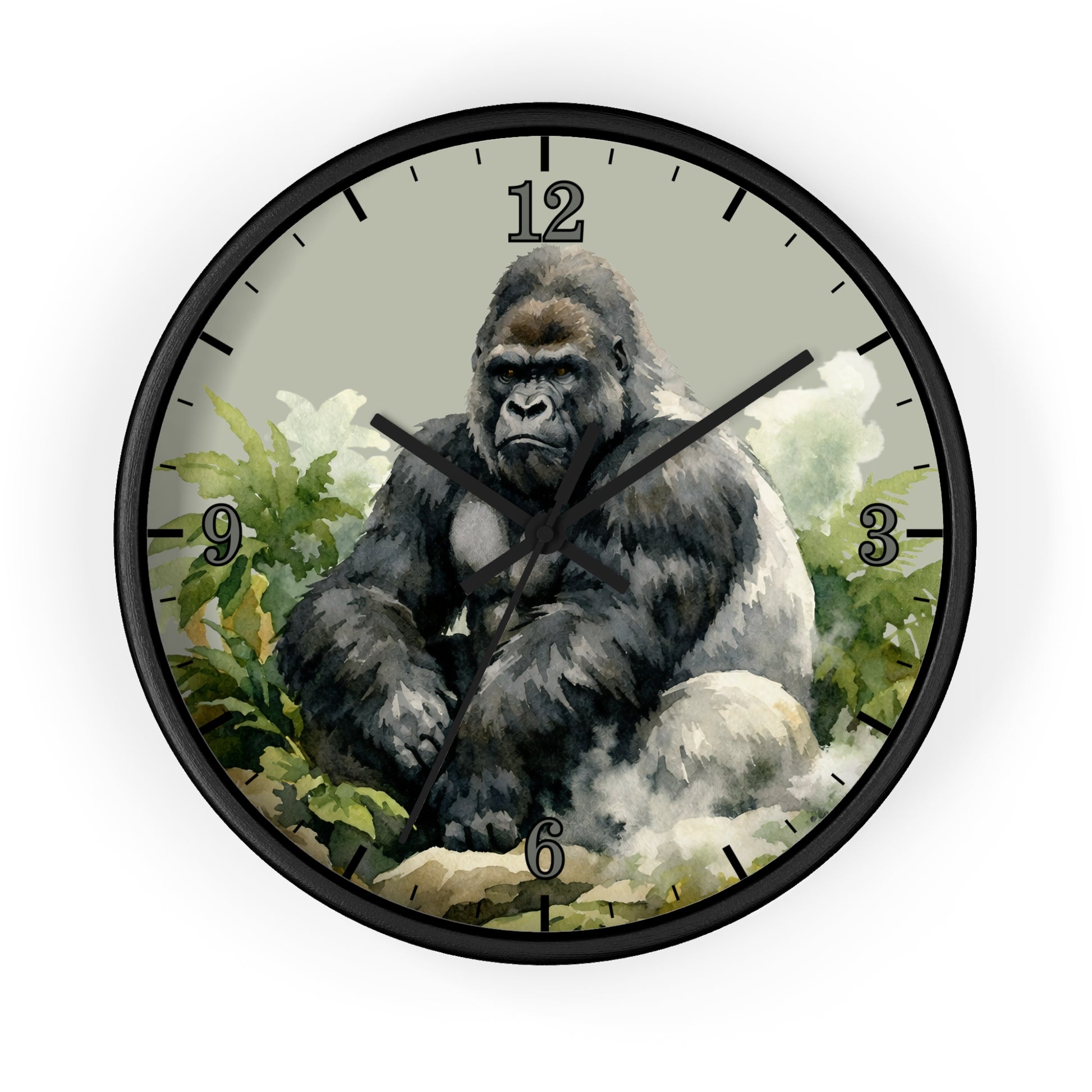 A round wall clock with a black frame and a printed illustration of a seated gorilla among green foliage on the clock face, shown against a plain white background.