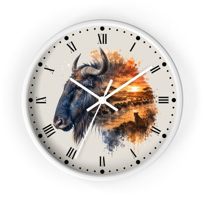 A round wall clock with a white frame and a cream-colored dial featuring a watercolor-style bison head on the left and an orange sunset landscape on the right. The clock has black Roman numerals, black dot hour markers, and white hands.